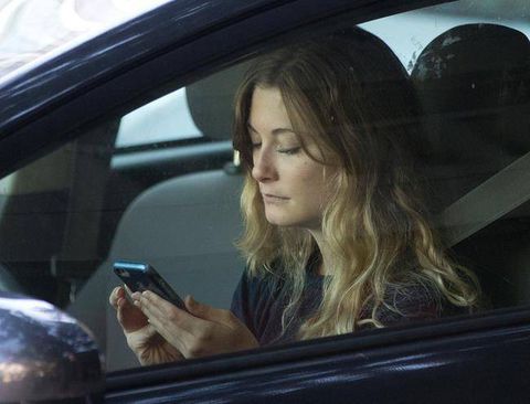In this Wednesday, June 22, 2016, file photo, a driver uses her mobile phone while sitting in traffic in Sacramento, Calif.