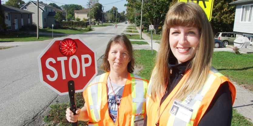 Crossing guard Debbie Daniel and supervisor Kristine Preston, pictured with the new stop sign.