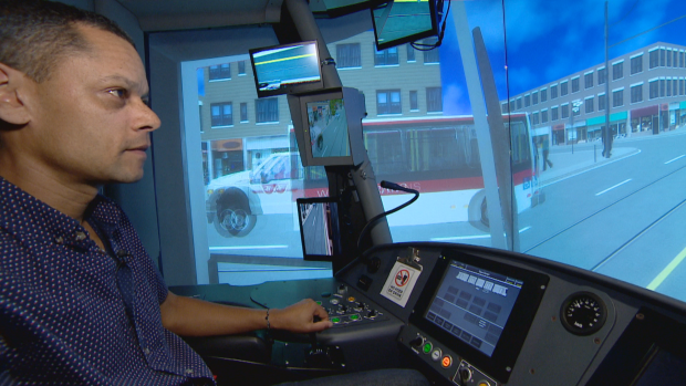 Galloway tests his driving skills on the TTC's streetcar simulator at Leslie Barns. (CBC)