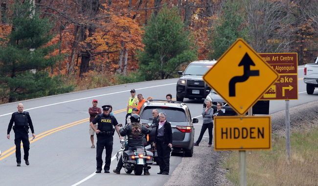 Pete Fisher Photography Killaloe OPP officers work at the scene of a motorcycle crash Saturday, Oct. 21, 2017 in Algonquin Park. A Barrie motorcyclist died in the crash. 