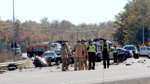 Police and firefighters are seen after a crash that killed a man and woman in Freelton, Ont. on Oct. 5. (Andrew Collins) 