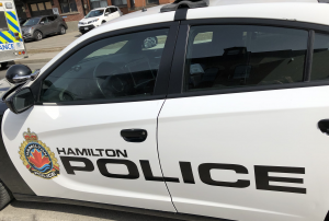 Hamilton police cruiser behind an ambulance