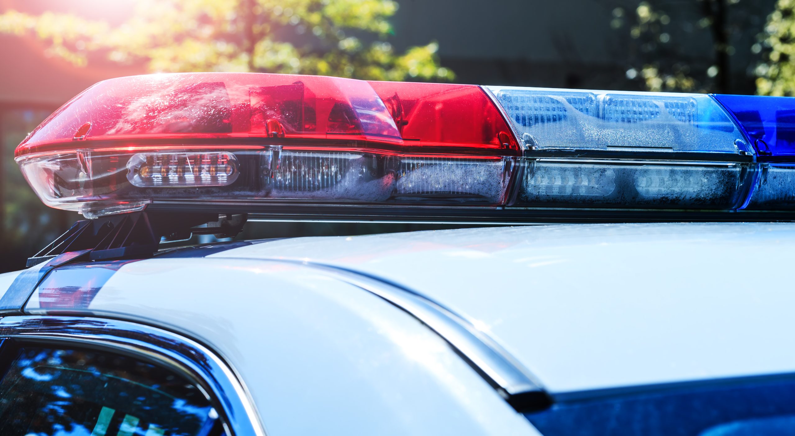 Close-up of red and blue police lights on top of a police vehicle.